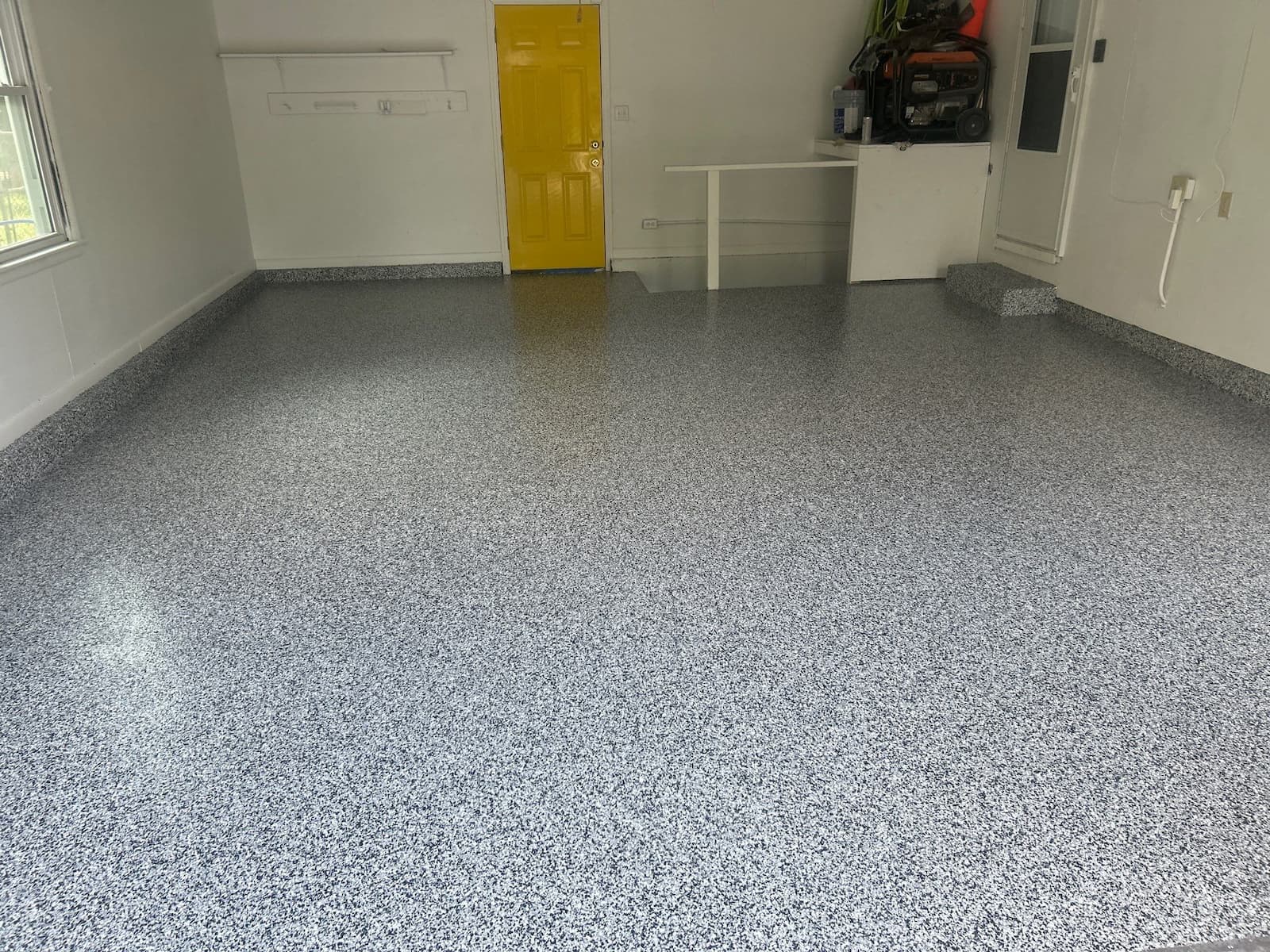 emptied garage concrete floor coated with polyurea